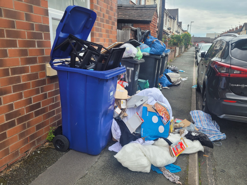 Bins along Hatrell Street in Newcastle-under-Lyme are overflowing with rubbish dumped along the pavement (LDRS).