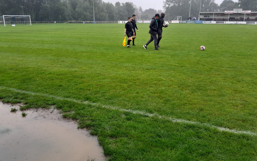 Referee Adekola Adeyami called off Hadleigh United v Cambridge City FA Cup tie at half time following pitch inspection (Picture: Nub News)