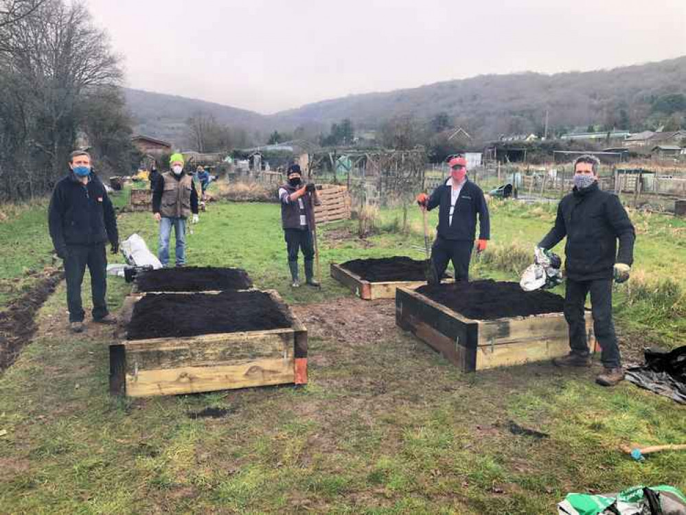 Rotarians and volunteers from The Space charity working on the allotment in Cheddar
