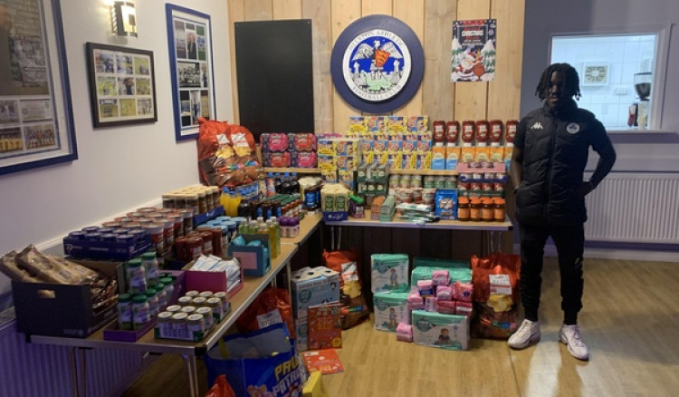 Osiah Spelman with his donation for the food bank. (Image: Supplied by SWNS)