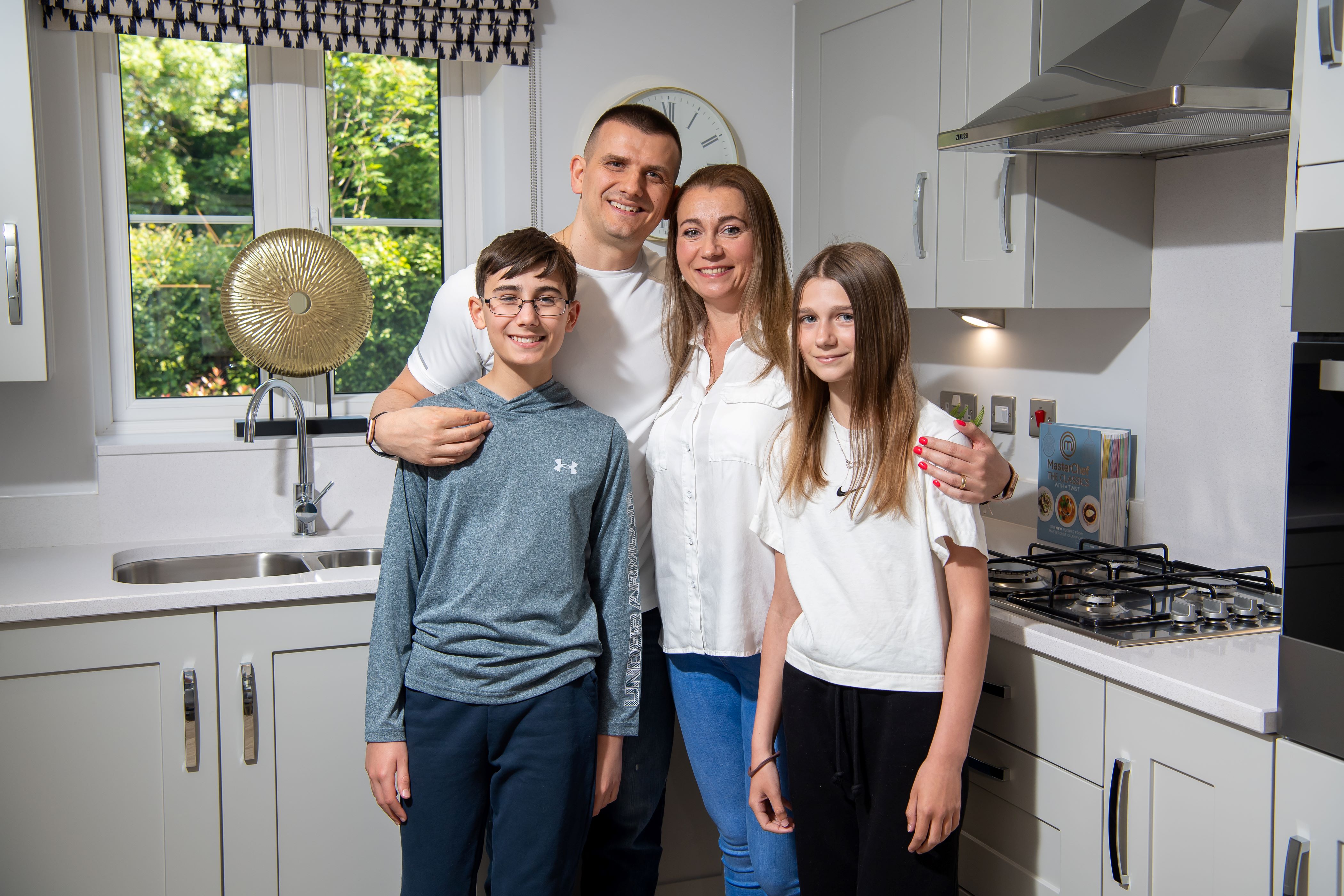 Pawel and Julia Pieciak with their children Sebastian and Natalia in the kitchen of their new home at Bellway’s Hazelwood development in Cubbington