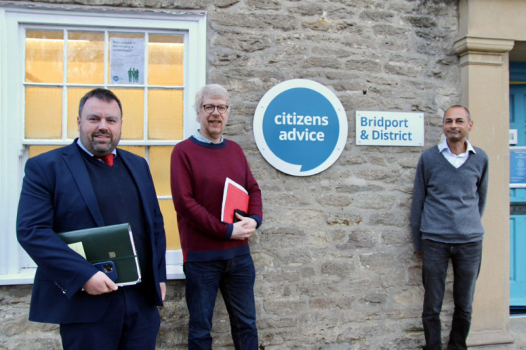 Daniel Cadisch and Rovarn Wickremasinghe from Bridport & District Citizens Advice pictured with West Dorset MP Chris Loder in 2022