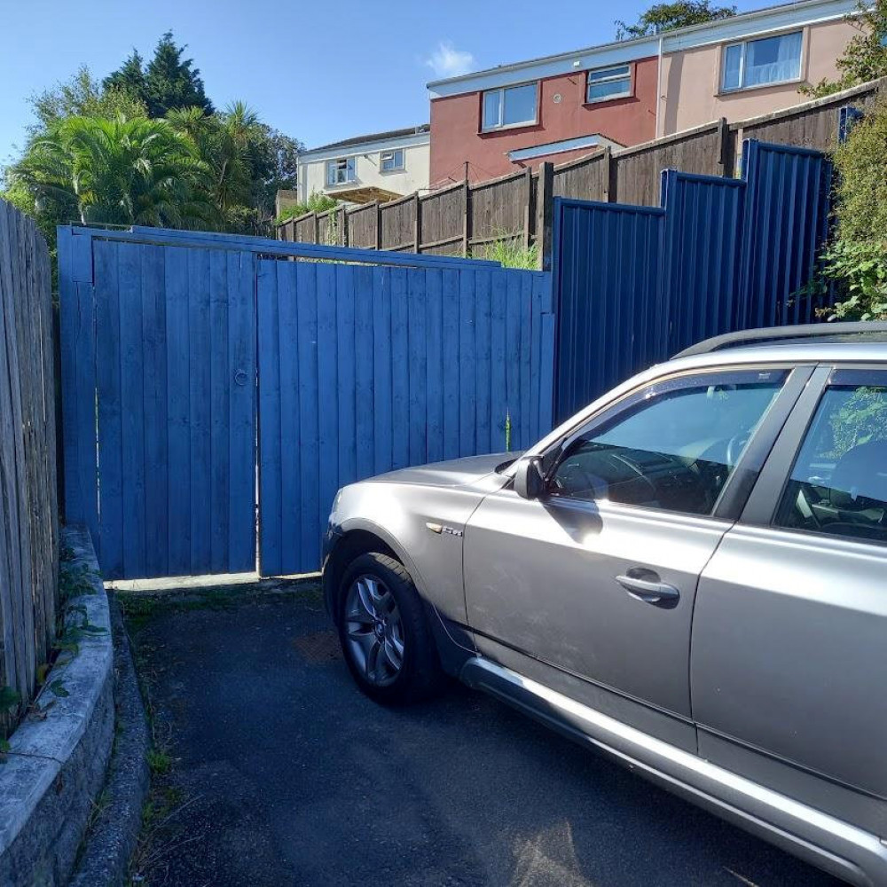 The metal gate that is claimed to have replaced a knocked down wall. (Image: Supplied by SWNS)