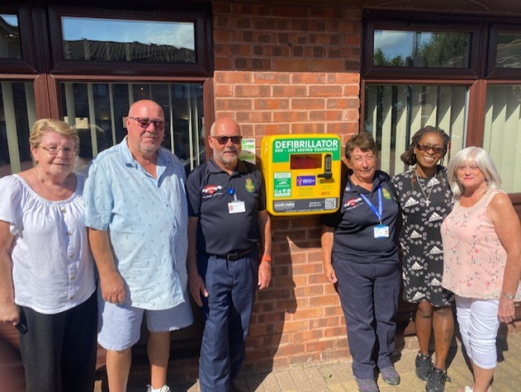 Residents and staff with First Responders at the new defib installation at Kynoch Court.