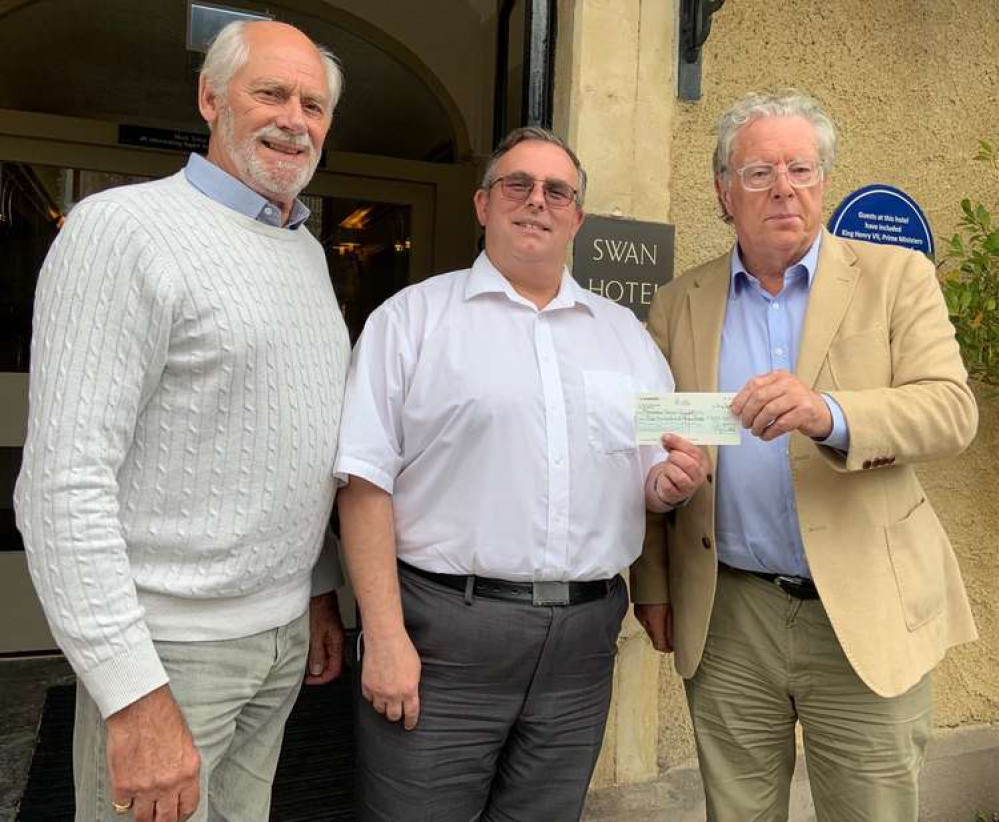 From right, Wells Mayor Philip Welch presents the car rally cheque to Mark Tobin watched by Roger Dollins