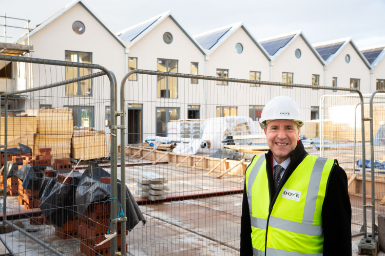 Dan Norris outside one of the builds now fitted with solar panels