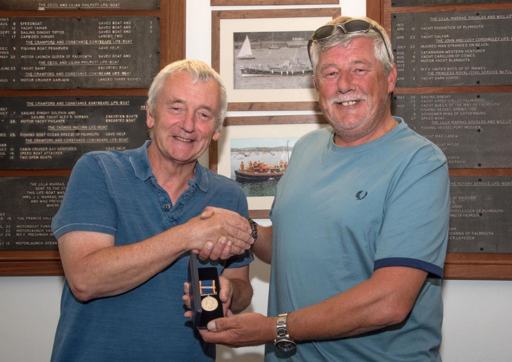 Falmouth RNLI Coxswain Jonathon Blakeston presented David Proud with the medal. (Image: Falmouth Lifeboat) 