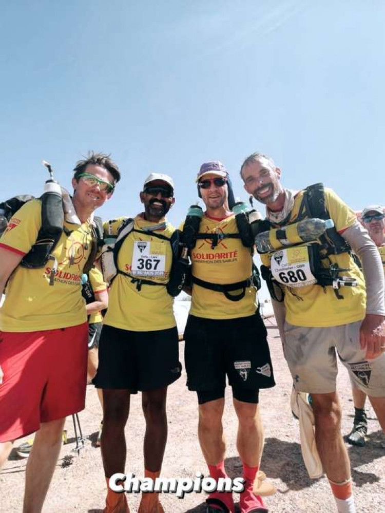 Ian Maclachlan (second right) and Chris Hewett (far right) after completing the Marathon des Sables