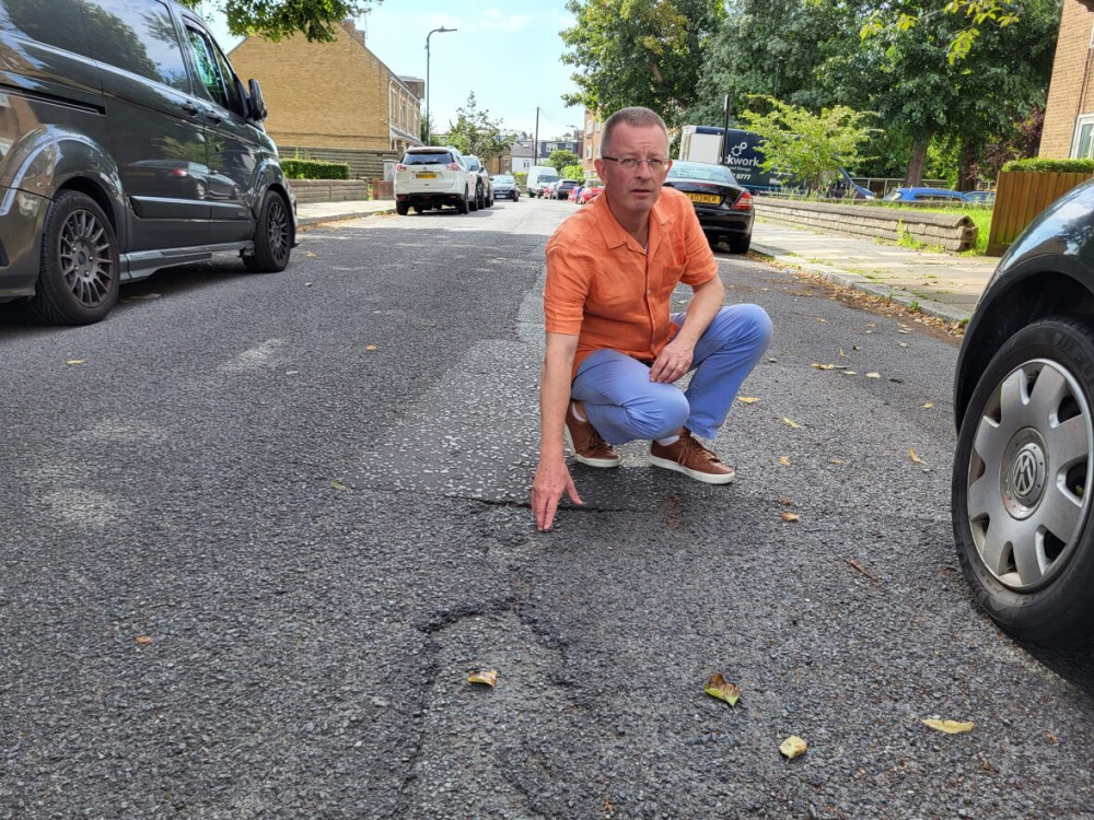 Liberal Democrat Councillor Andrew Steed on Church Path where potholes are found (image supplied)..