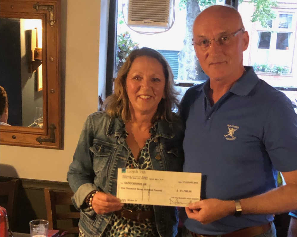 Society secretary Doug Glassford handing over the cheque to Michelle Higgins at a presentation evening at The Old Bakery (image supplied)