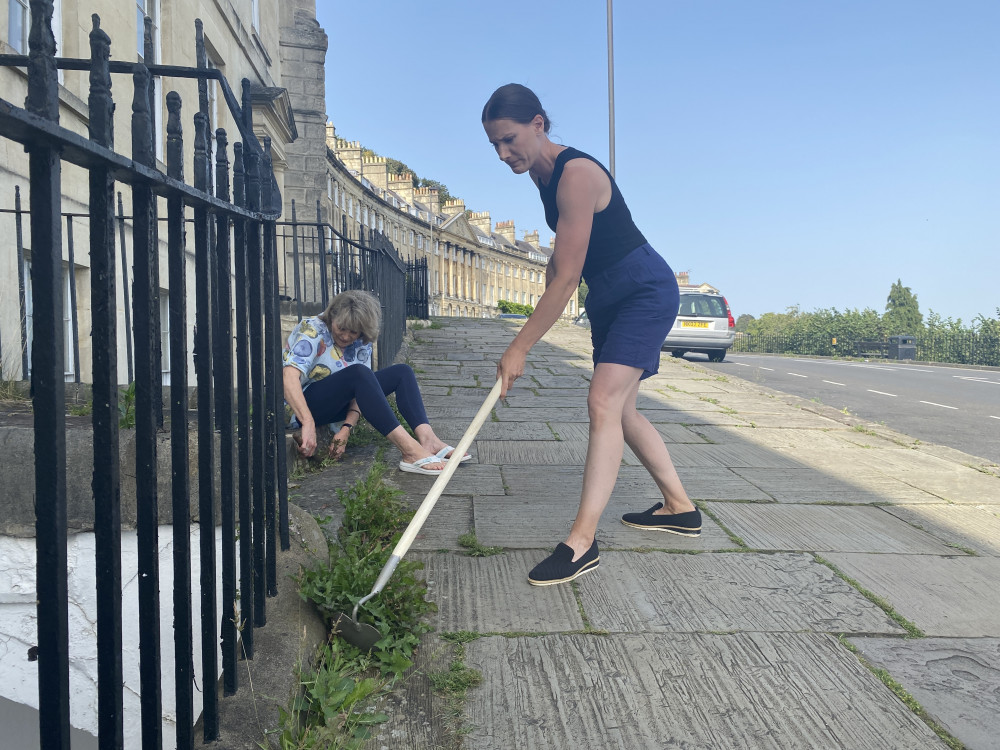 Janice Legge (left) and Holly Ford (right) tackle weeds on Camden Crescent (Image: John Wimperis) - free to use for all partners