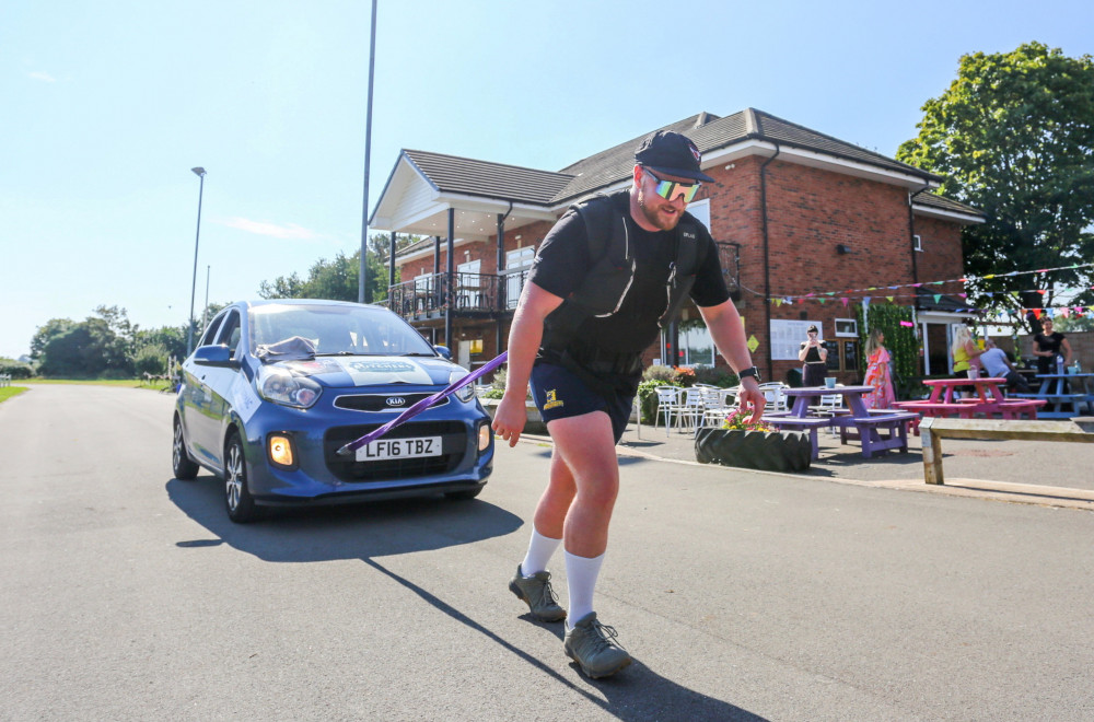 Strongman Matt Cooper, 30, hauled a one-tonne Kia Picanto continuously 145 times around a 400m cycle track (image via SWNS)