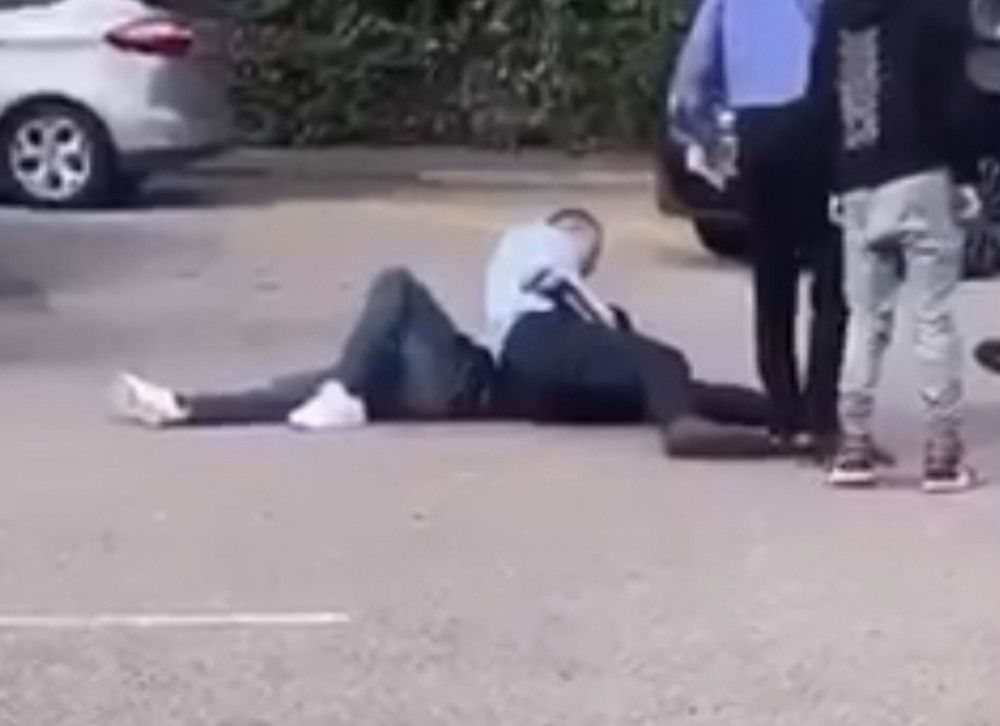 Hitchin hero. Priory school head Geraint Edwards seen grappling with an aggressive juvenile in the car park of the learning establishment on Bedford Road. CREDIT: Supplied 