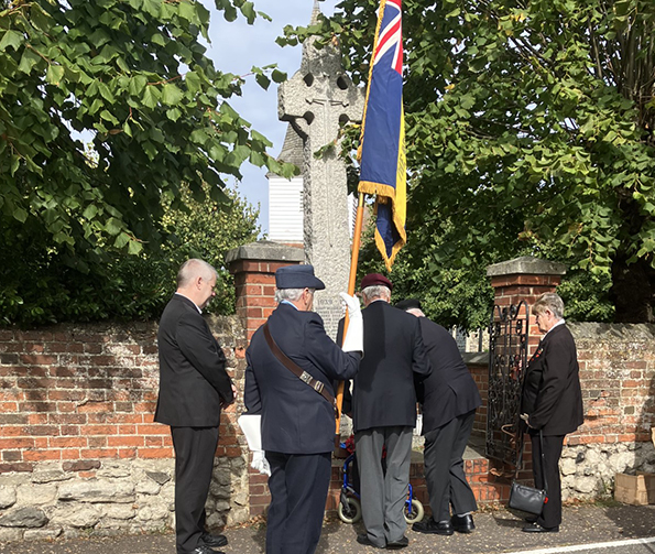 Branch president Maureen McPherson carried the standard at the wreath-laying. 