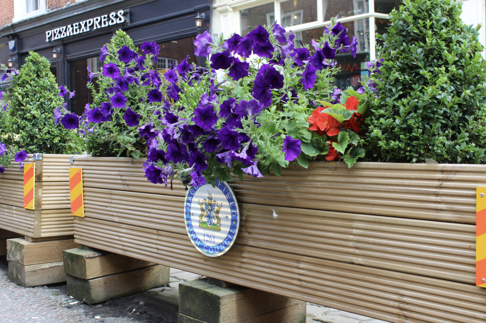 Pretty floral displays on Market Place in Macclesfield. (Image - Macclesfield Nub News)