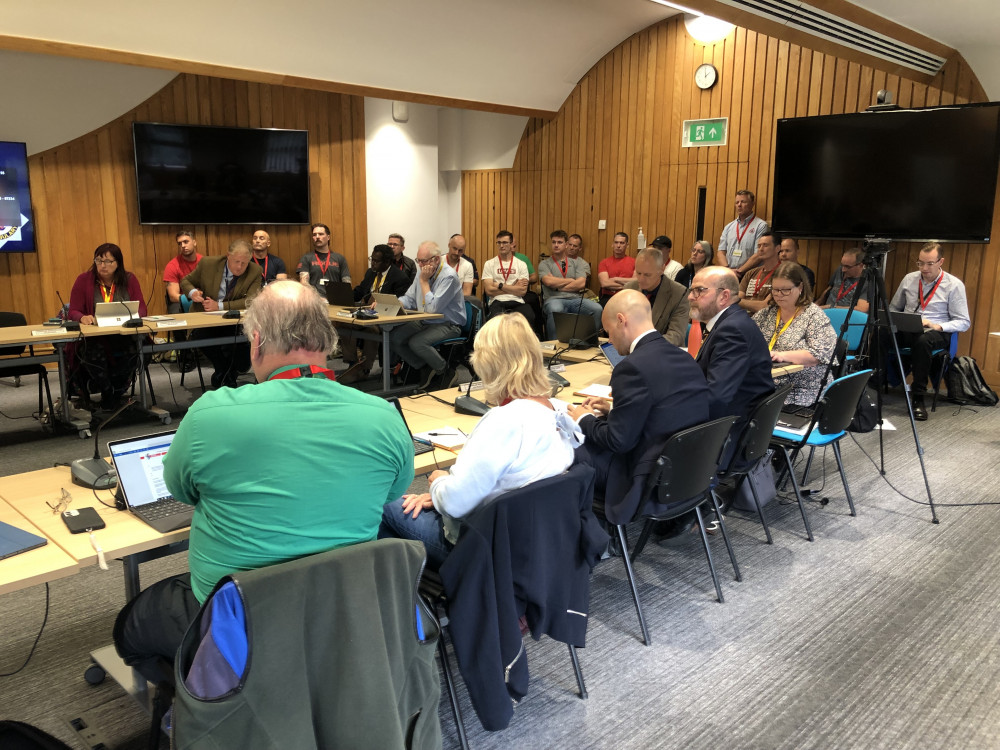 Avon Fire Authority committee with more than a dozen firefighters who attended the meeting in the background on Wednesday, October 4, 2023 (Image: LDRS, free to use