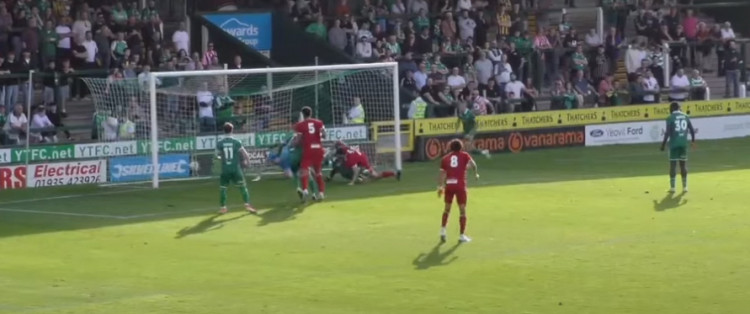 Charlie Hughes managed to squeeze the ball over the line after a good initial save from Joe Day.