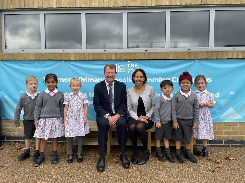 MP Munira Wilson (right) and Headmaster David Price (left) with school children. (Photo: Supplied)