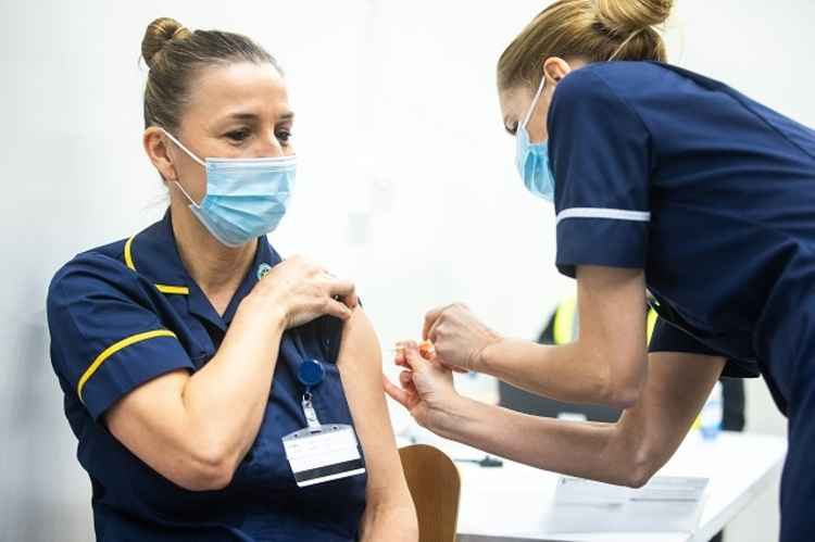 A social care worker being vaccinated