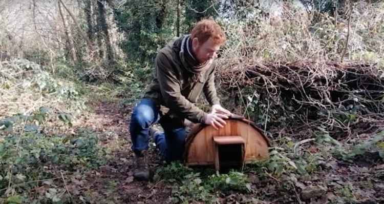 Biodiversity Officer Elliot Newton demonstrates a hedgehog house (Screenshot from Kingston Libraries YouTube Channel, Reading Nature Episode 10: Hedgehogs)