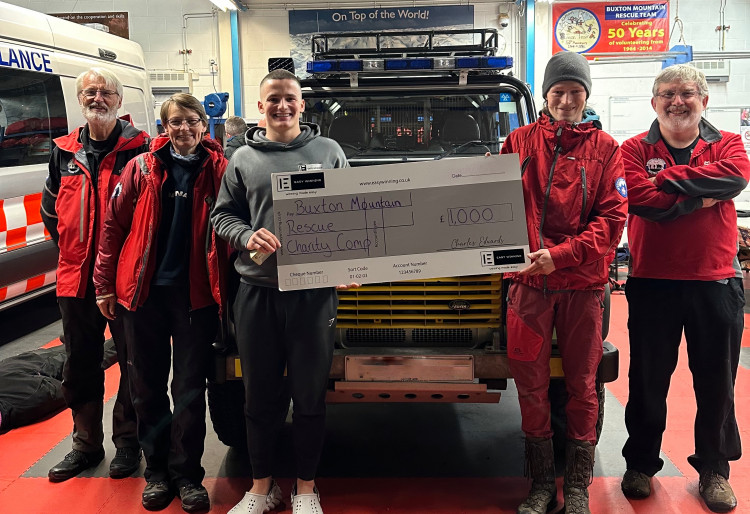 Charles and Callum hold the cheque at Buxton Mountain Rescue HQ. (Image - Easy Winning Limited)