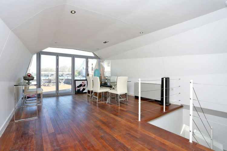 It features a stylish dining area with access to the boat's spacious deck