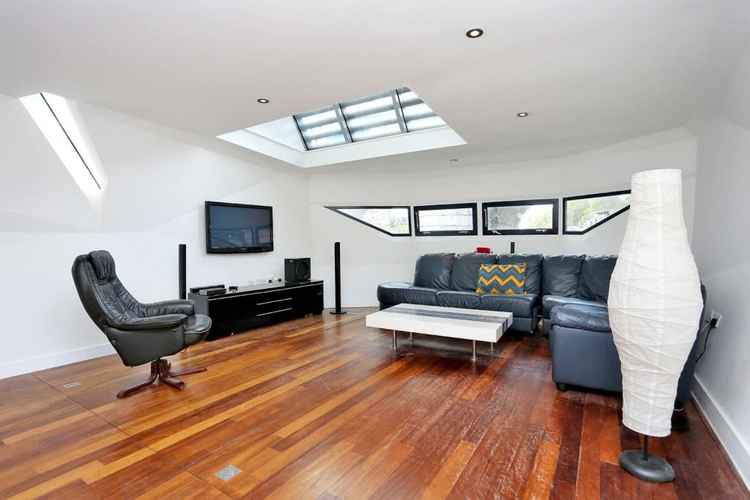 The living room also has solid-wood flooring and plenty of windows to give it an airy feel