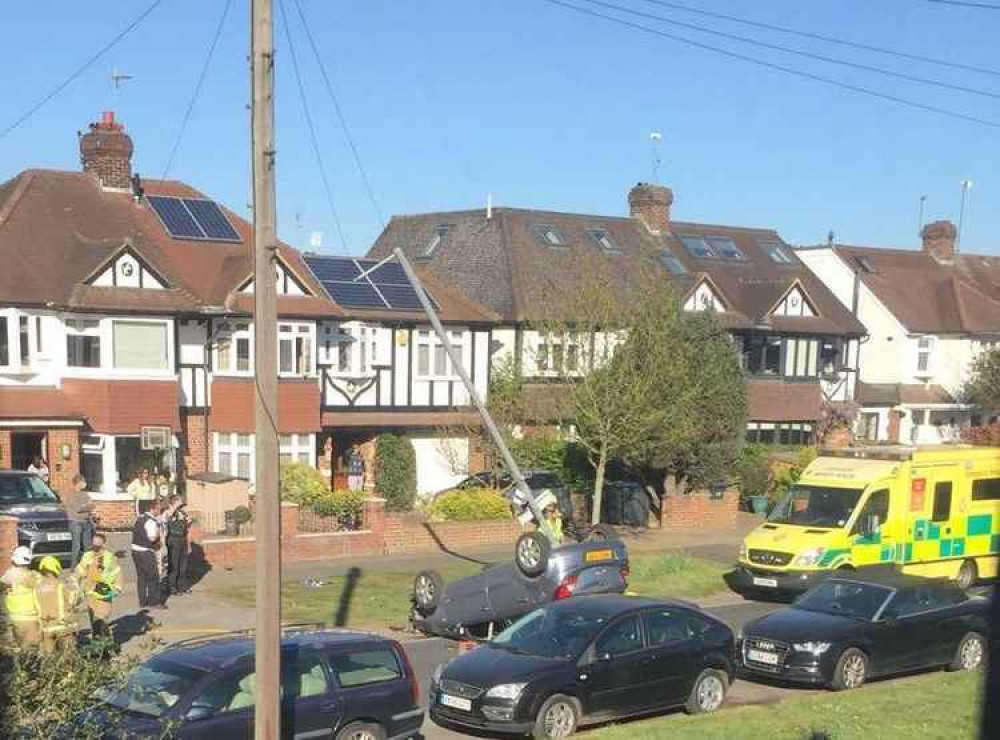 A photo of the accident showing a car flipped over and an ambulance on the scene / Photo: Lisa Maguire