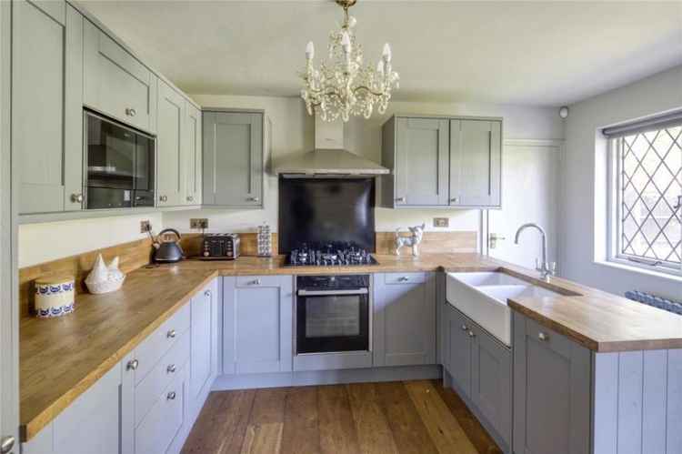 The house has a modern kitchen with chic grey cabinets