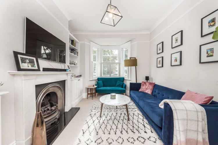 The front reception room room with fireplace and bay window