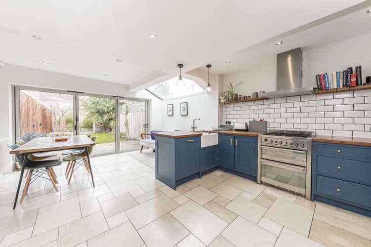 The modern open-plan kitchen and dining room with easy access to the garden via folding doors