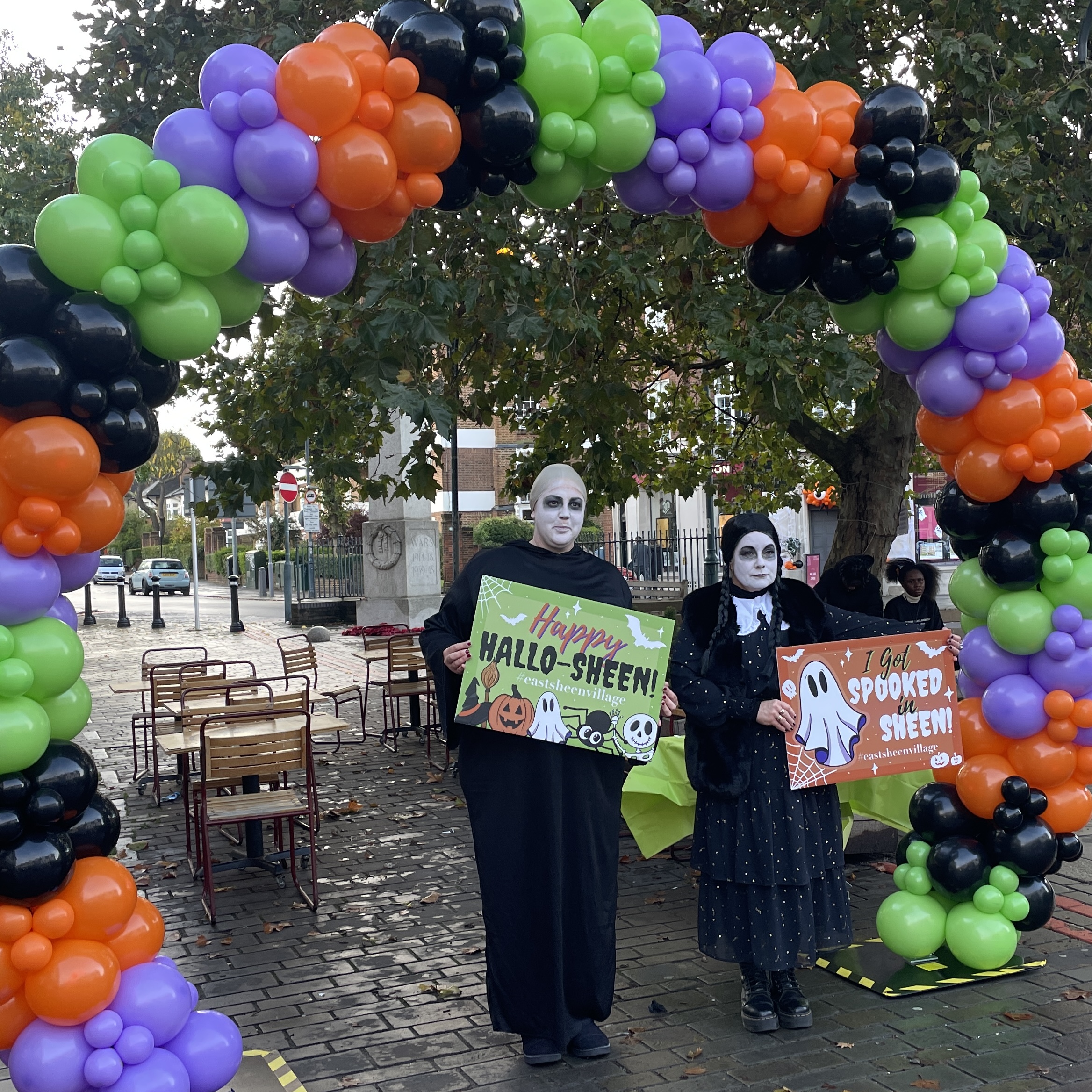 Uncle Fester & Friday at the ready under the Halloween Balloon Arch