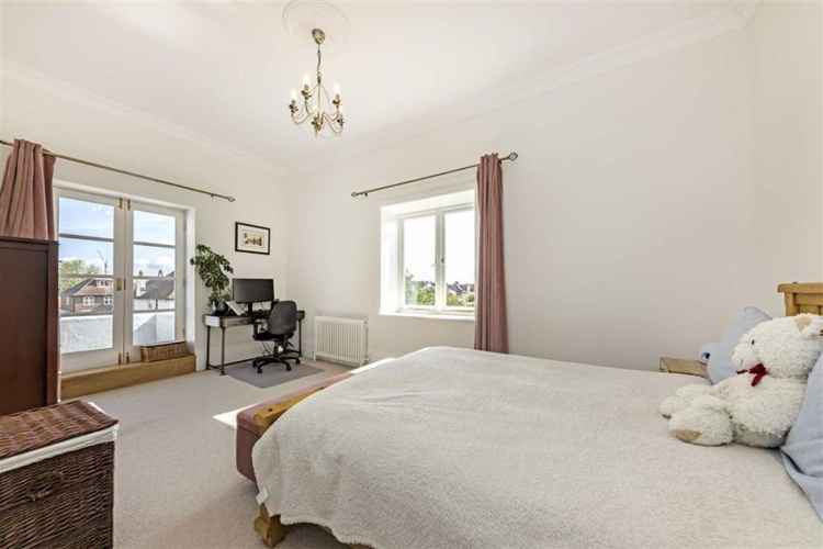 The master bedroom featuring balcony doors leading onto the private roof terrace