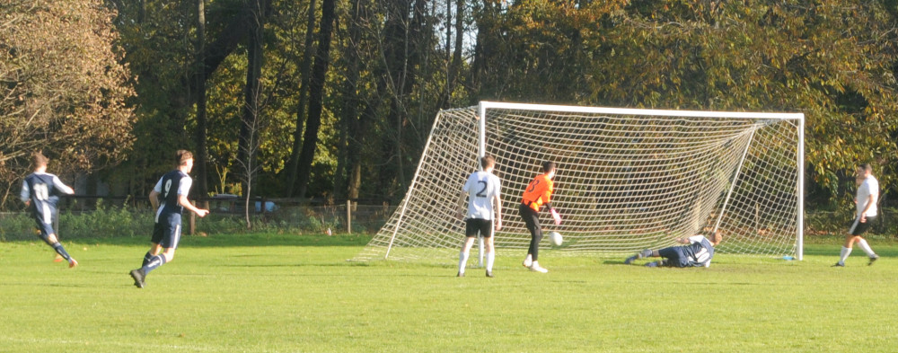 Marcus Lawrence wheels away after scoring the opener for Woolverstone against Tuddenham (Picture: Nub News)