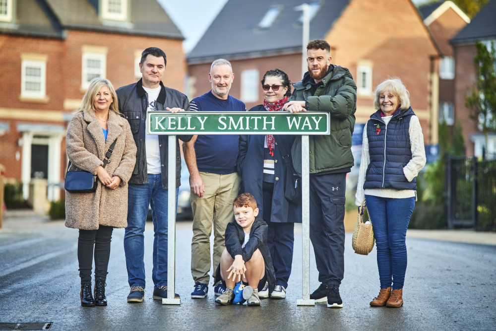 Kelly Smith's family at with the sign gifted to them in honour of Kelly's memory. (Image - David Wilson Homes)