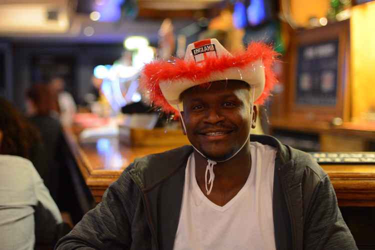 A punter smiles earlier in the night when England were riding high 1-0 against Italy (Credit: Nub News)