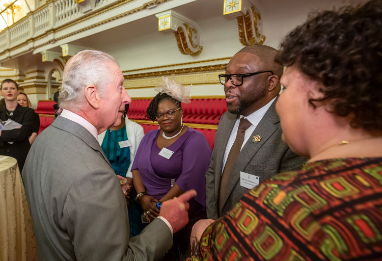 His Majesty talking to Royal Star & Garter’s Head of Care Quality Walter Chikanya, at the reception at Buckingham Palace (Photo: Ian Jones Photography)