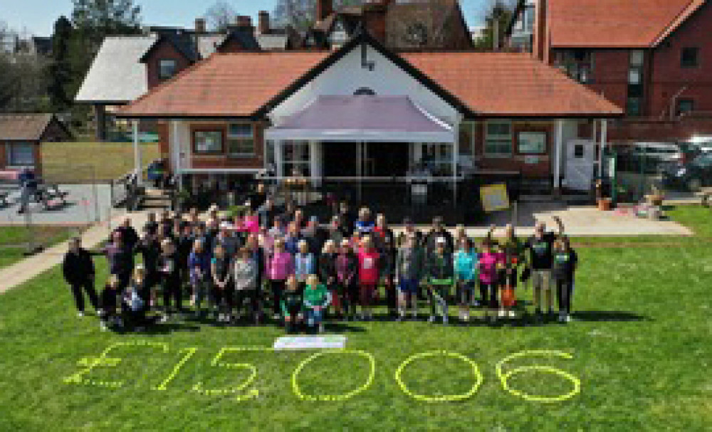 Members of Penarth Lawn Tennis Club celebrate their fundraising total for Velindre Hospital.