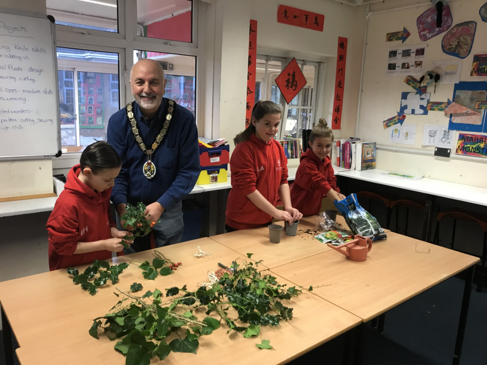 Mayor Philip Campagna making posies and planting bulbs