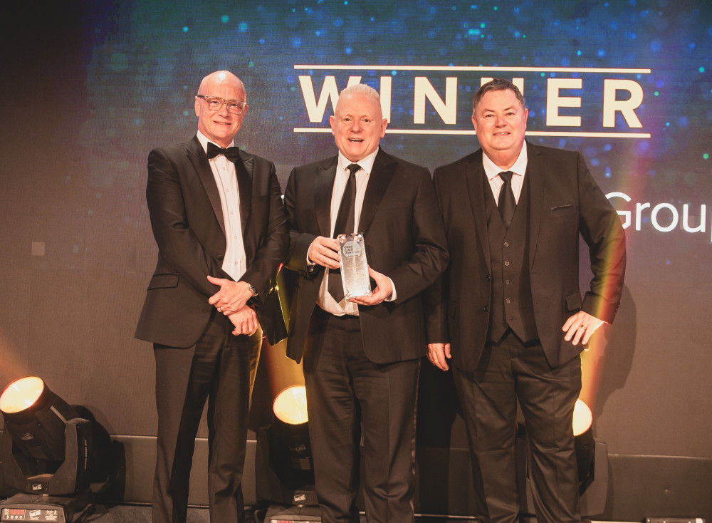 Swansway Director Peter Smyth, centre, collects his trophy from Tim Smith, left, head of UCA headline sponsors Black Horse Motor Finance, and awards night compere Mike Brewer (Swansway Motor Group).