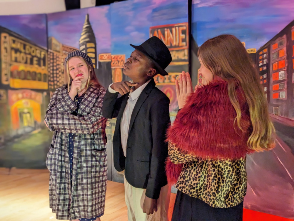 Lottie as Mrs Hannigan, Israel as Rooster and Jessica Lily plot to claim Annie and the Warbuck's reward money. (Photo Credit: Twickenham School).