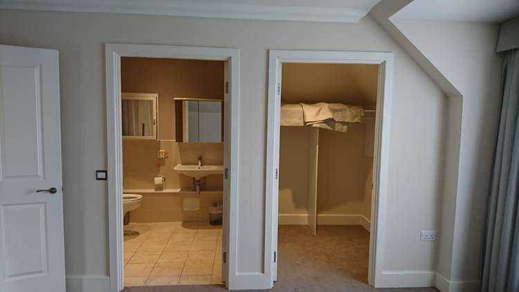 Entrances to the second ensuite bathroom and a walk-in wardrobe (Image: Coombe Hill Manor)