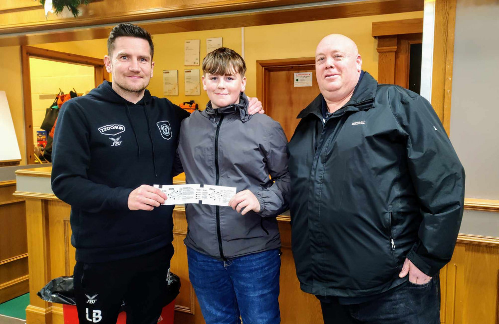 Crewe Alex manager Lee Bell, handing over the free Barrow tickets to Stephen Sugarman and his son Lewis (Ryan Parker).