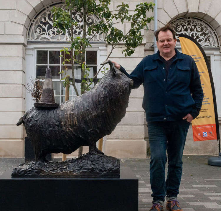 Alex pictured with the winning statue in Kingston marketplace (Image: Ollie G Monk)