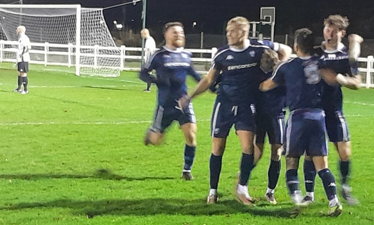 Reece Josselyn mobbed by celebrating Brantham team-mates after corker of a goal (Picture: Nub News)
