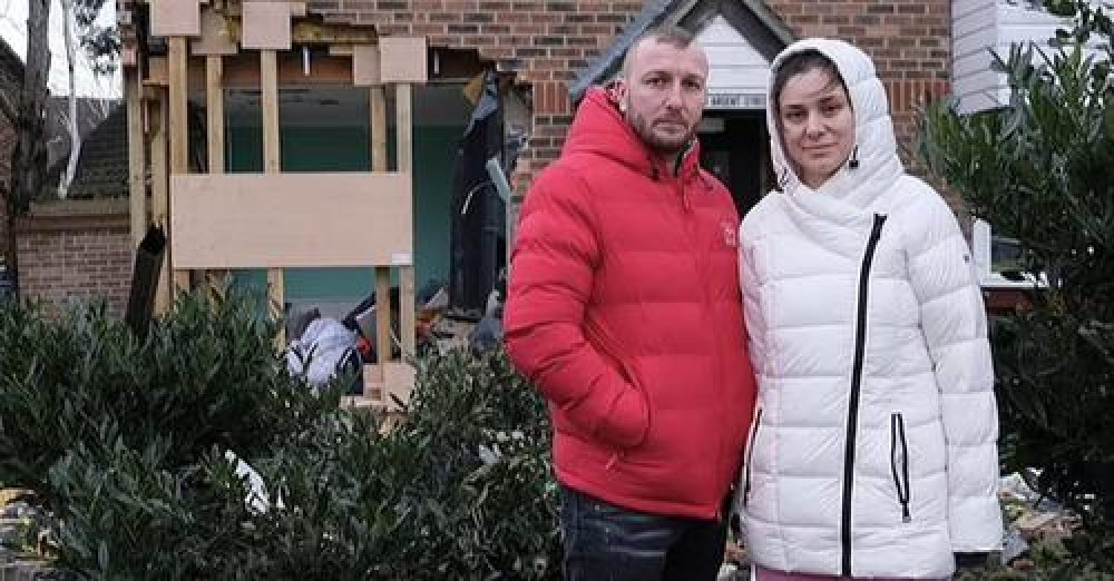 Ana and Florin outside their wrecked home.