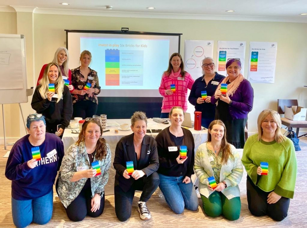 The parenting team showing the invest in Play logo ‘six bricks’ logo, with director Caroline White third from front left (Image - Stockport NHSFT)