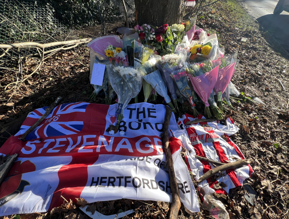 Stevenage FC pay tribute to tragic Ollie Gatfield after 19-year-old died in A602 crash in Hitchin. PICTURE: A shocked community comes together to pay tribute by leaving a large number of flowers and messages at the scene of the accident on the A602 in Hitchin. CREDIT: Hitchin Nub News