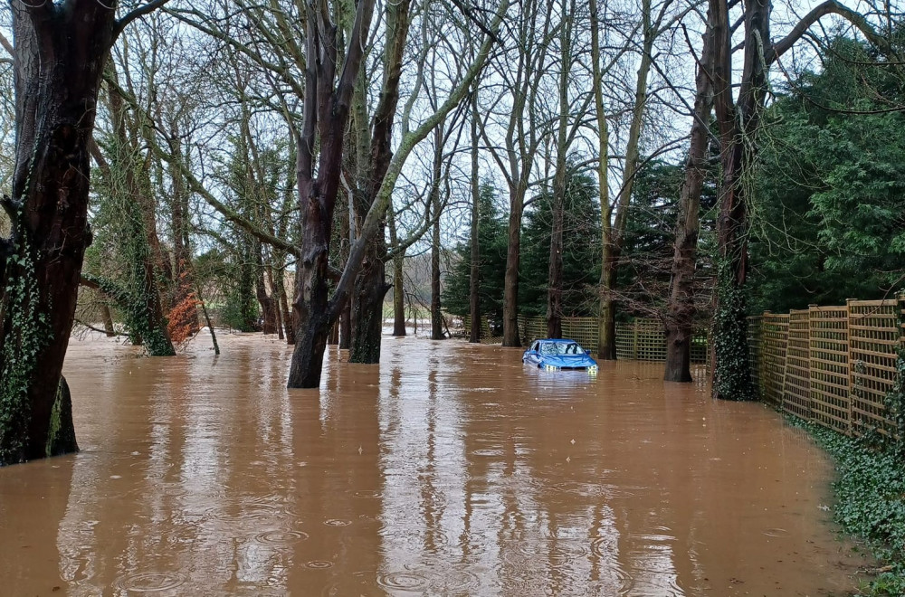 BMW driver rescued after trying to drive through flooded road 