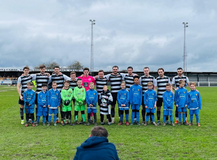 Tilbury FC before the matc h with their mascots from East Thurrock Youth.